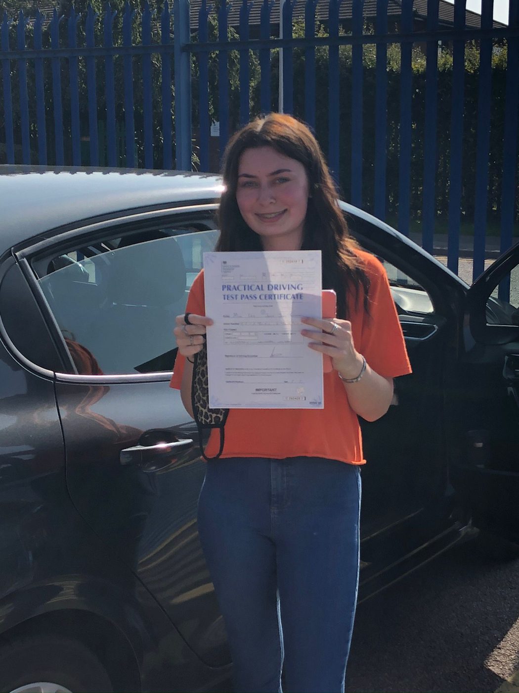 Learner celebrating her driving test pass with Ian's School of Motoring